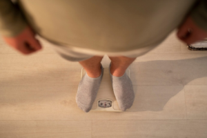 person looking down on weighing scale
