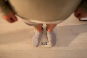 person looking down on weighing scale